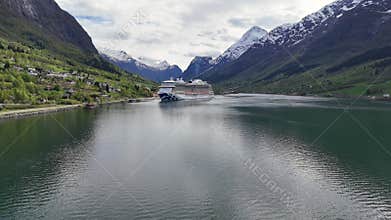 Drone shot of the cruise vessel Sky Princess docked at the village of Olden, Norway during daytime