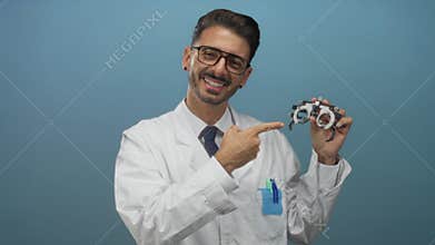Man points finger to phoropter in studio with blue backdrop; confidence professionalism precision expertise