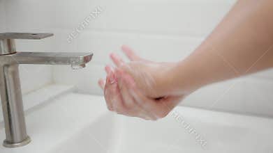 Closeup hands in sink with foaming soap, feeling hygienic and refreshed for prevention virus spread, close-up woman washing hands