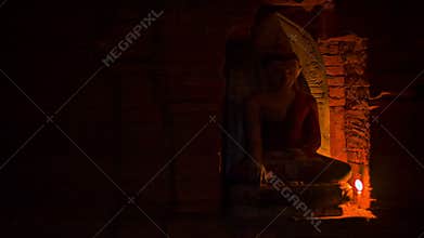 Buddha candlelit statue at the ancient temple