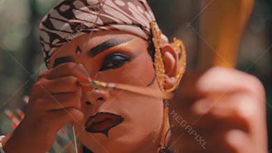 Close-up of a Focused Javanese Archer Aiming His Bow