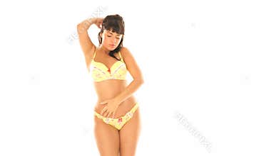brunette dancing in yellow lingerie