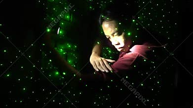 Artistic Pose Under Green Laser Lights