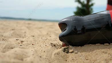 Refreshing Black Soda Bottle in Beach Sand - Summer Drink Ads and Water Conservation Metaphors &#x28;Drainage, Ice