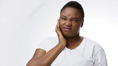 Woman experiencing pain in healthcare setting with isolated background