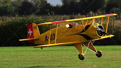 Bucker Bu 133 Jungmeister RC model landing on a grass airfield