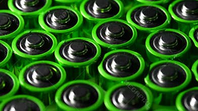 Lots of discharged old batteries, rotates. Used battery on background. Hazardous garbage concept