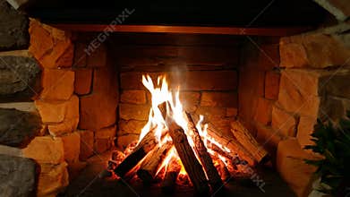 Cozy evening by the fireplace with crackling wood in a rustic stone setting