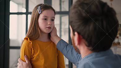 Caring Caucasian dad man guy male touching talk offended sad little child kid at home babysitter father parent apologize