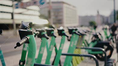 Row of Electric Scooters Parked in Urban Setting on a Sunny Day