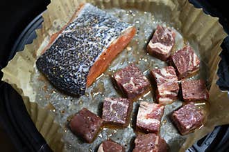 Air fryer lemon pepper salmon and beef in parchment paper. Tasty cooked steak, healthy and easy meals