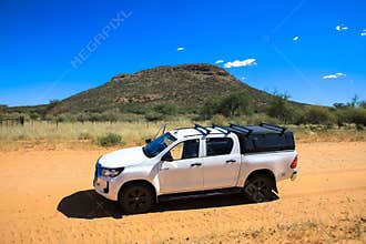 Toyota Hilux standing in the middle of the savanna.