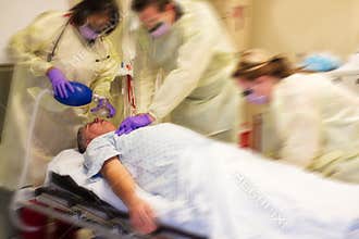Code blue team resuscitating a patient
