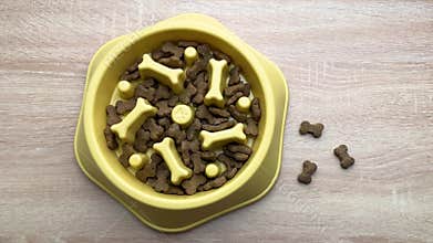 Dog food slowly disappearing from a slow feeder bowl