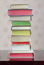 A column of hardback colorful closed books