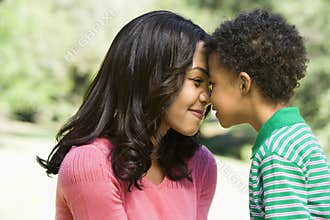 Mother and son nuzzling.