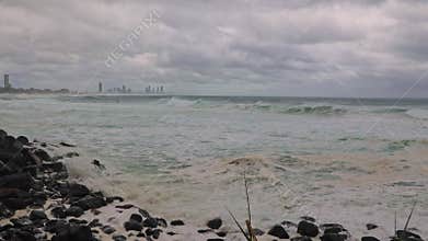 Small windswept waves and rough surf roll into the beach on the Gold Coast.