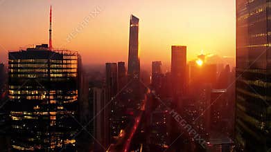 Aerial View of Cityscape at Sunset with Orange Sky