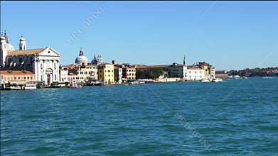 Traffice in the blue sea and building on the bank of Venice.