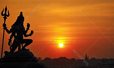 Silhouette of Shiva Statue at Sunset, Spiritual Serenity in India