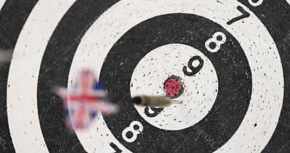 Player aims and throws dart in attempt to hit bullseye