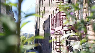 New York City building architecture, Manhattan. Residential house exterior. Red brick, fire escape.