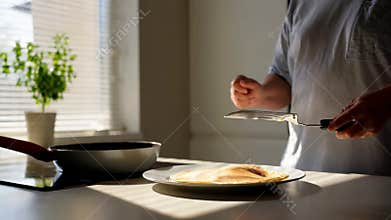 Hand spreading butter knife bread slice breakfast preparation kitchen counter stock footage Generative AI
