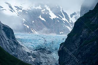 Valley in Endicott Arm with lowering fog ,craggy mountains and icy glacier