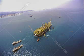 Tugboats carrying oil & gas FPSO rig
