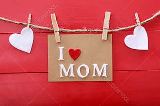 Mothers day message with clothespins over red wooden board
