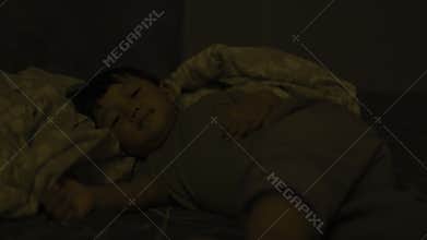 Child Is Sleeping On The Bed In The Afternoon