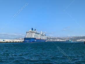 Celebrity Cruise ship docked in Tangier harbour under clear blue sky