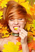 fashion style happy fall woman smiling joyful holding autumn yellow maple leaf