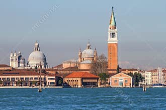 Iconic Venetian cityscape showcasing San Giorgio Maggiore Basilica's bell tower and domes, with Santa Maria della Salute