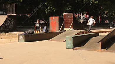 Teens practicing skateboard