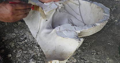 lose-up of a skilled artist shaping a fibre sculpture