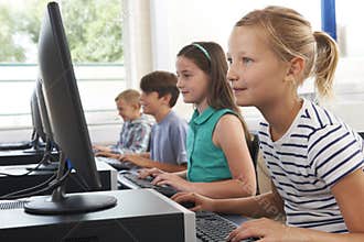 Group Of Elementary School Children In Computer Class
