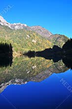 Mountain with reflection on a lake during Autumn