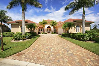 Florida luxury home with paver block driveway