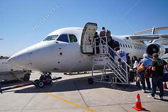 Passengers board an Aerovias DAP British Aerospace BAe 146 regional airliner at Arturo Merino Bentez International Airport