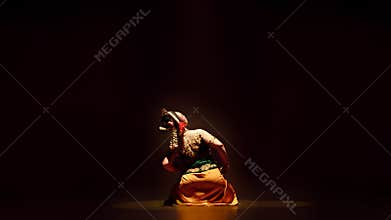 Traditional Javanese Dancer Leaning Gracefully Under Warm Stage Light