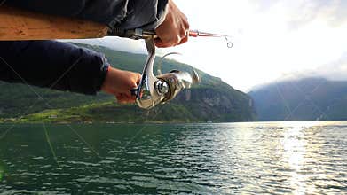 Woman fishing on Fishing rod spinning in Norway