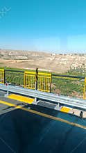Highway Bridge with Yellow Guardrail and Landscape View