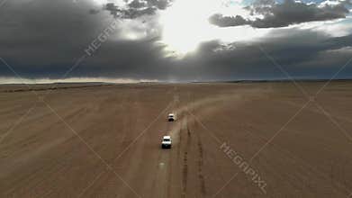 Offroad vehicles cross Gobi Desert dunes in Mongolia through remote sand country, desert convoy, sand dunes, dune crossing