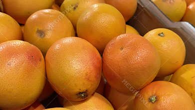 Fresh Grapefruits for Sale Displayed in Rustic Wooden Crates at Local Fruit Market