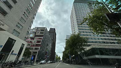 Low angle view of modern high rise buildings and cloudy sky over