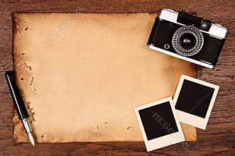 Old paper, ink pen and vintage photo frame with camera