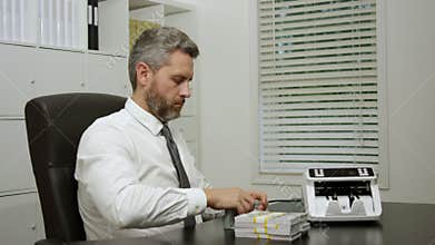 Banker counting cash in office. Banker managing finance. Banker controlling money and verifying dollars. Banker working in office