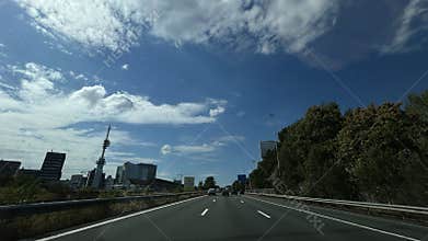 Multilane highway approaching Amsterdam business district skyline with modern
