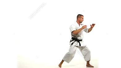 Karate. Man in a kimono hits foot on the white